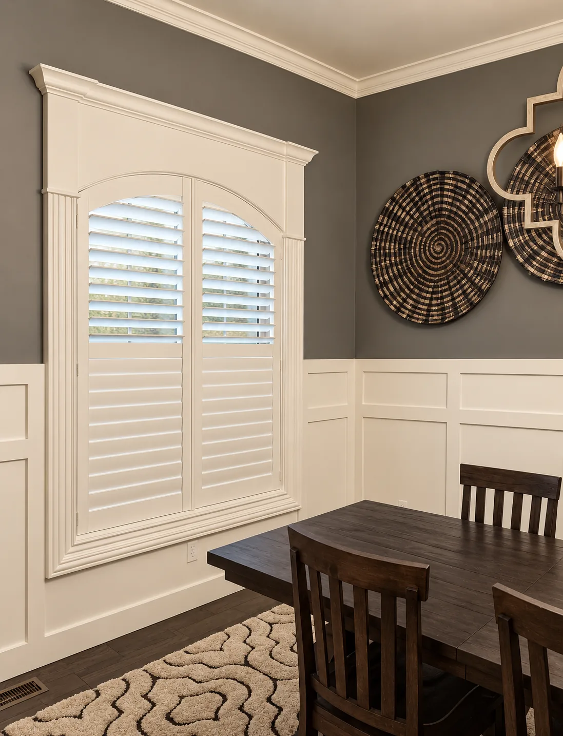 Custom shutters fitted to an arched dining-room window